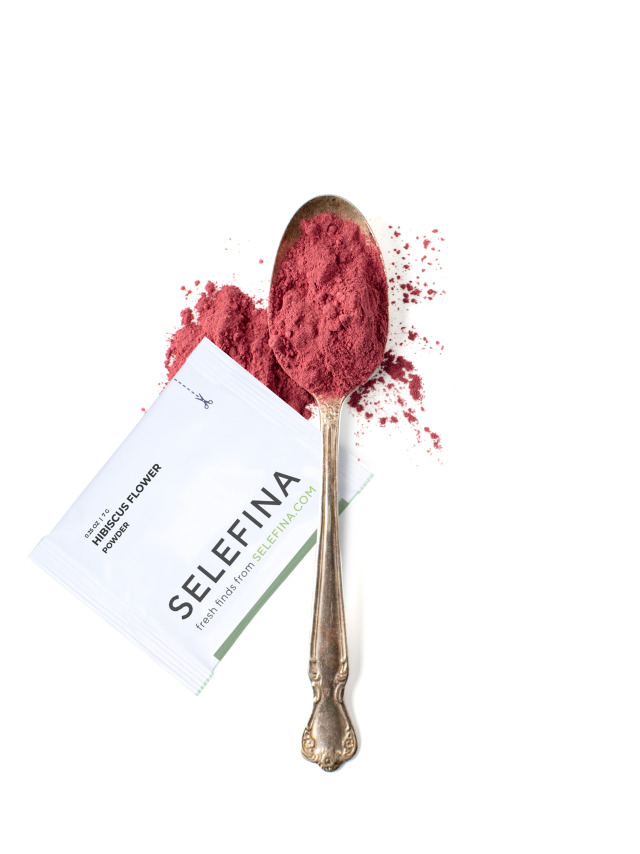 A Selefina Try-Me packet of hibiscus flower powder beside a spoonful of it