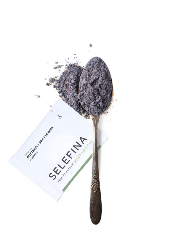 A Selefina Try-Me packet of Blue Lagoon Moon Milk drink mix beside a spoonful of it
