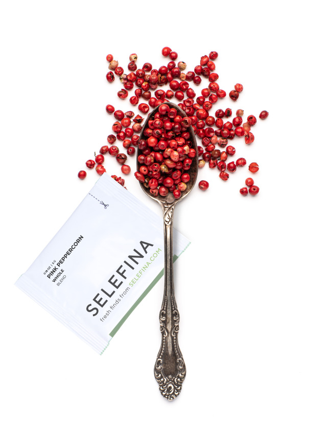 A Selefina Try-Me packet of pink peppercorns beside a spoonful of it