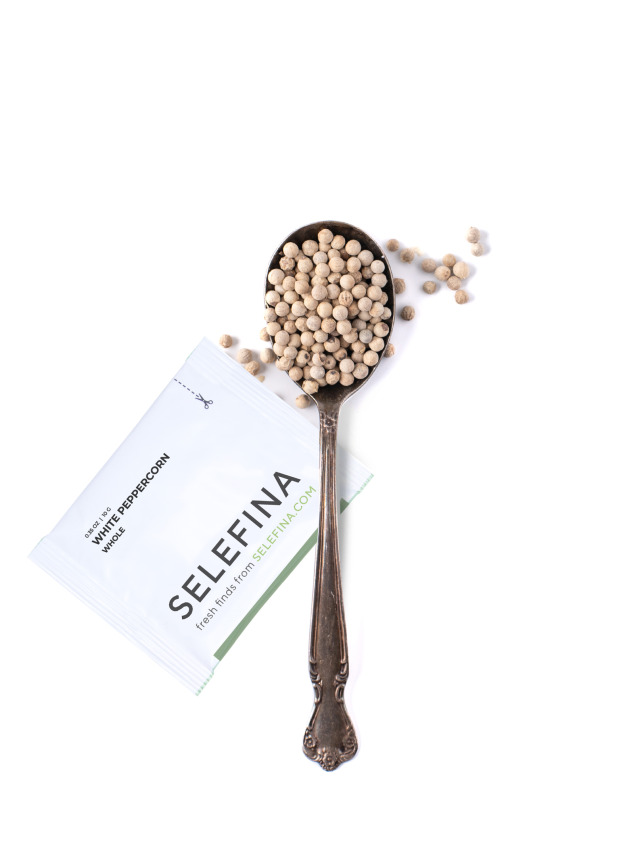 A Selefina Try-Me packet of whole white peppercorns beside a spoonful of it